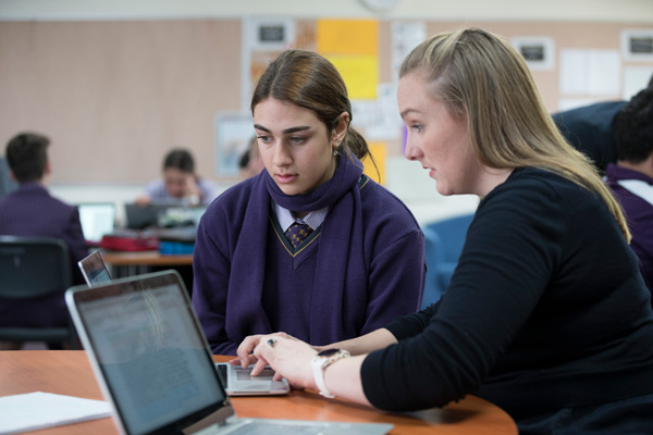 Teacher providing feedback to a student