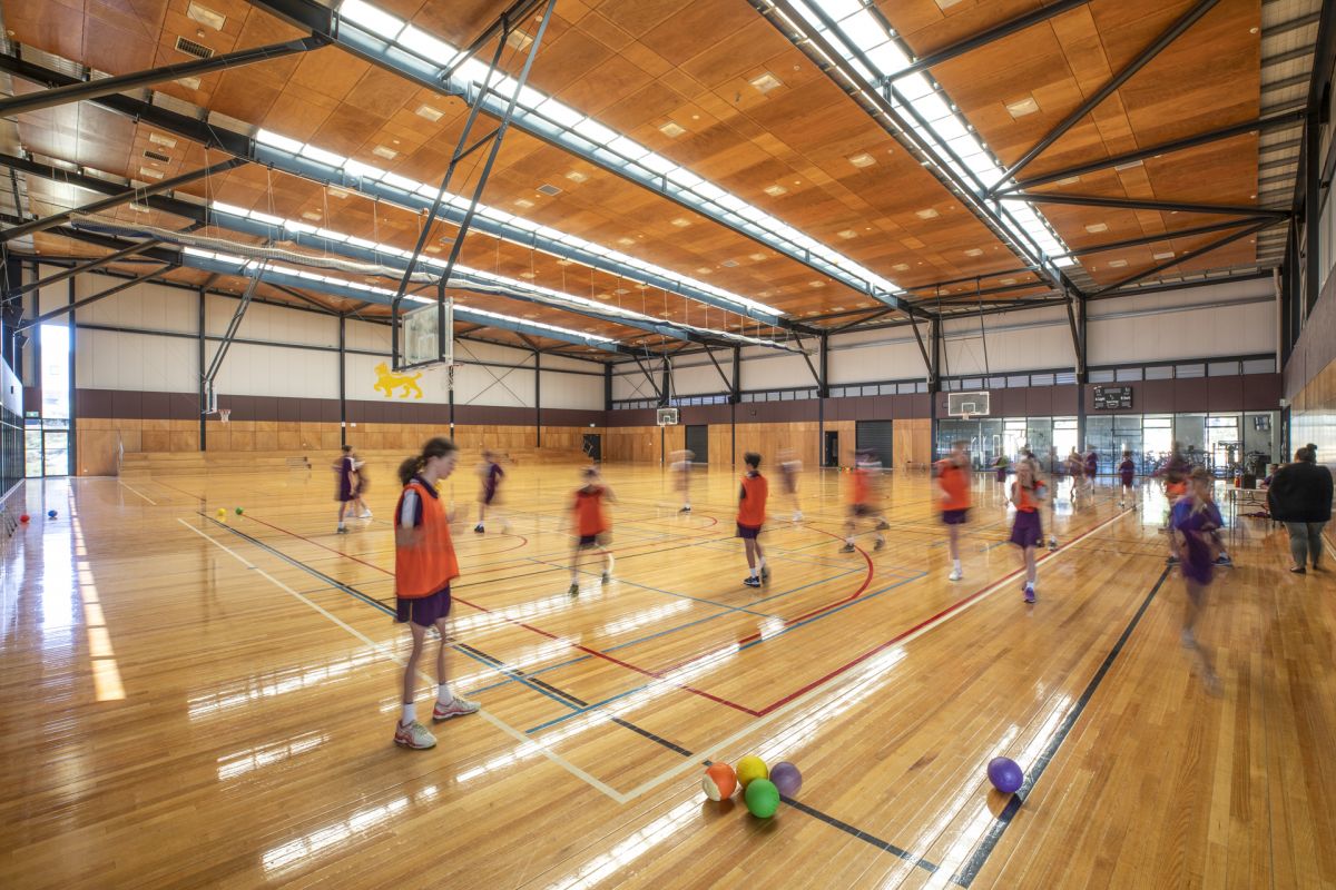 Kids playing basketball on an indoor court