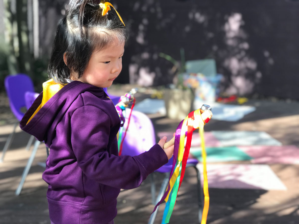 ECLC student Amber experiments with the effects of ribbons while dancing. 