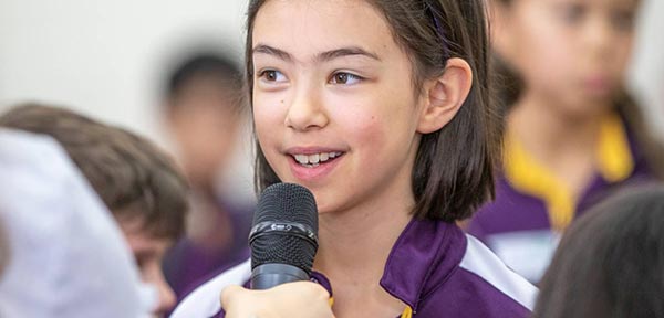 Student speaks in to a microphone