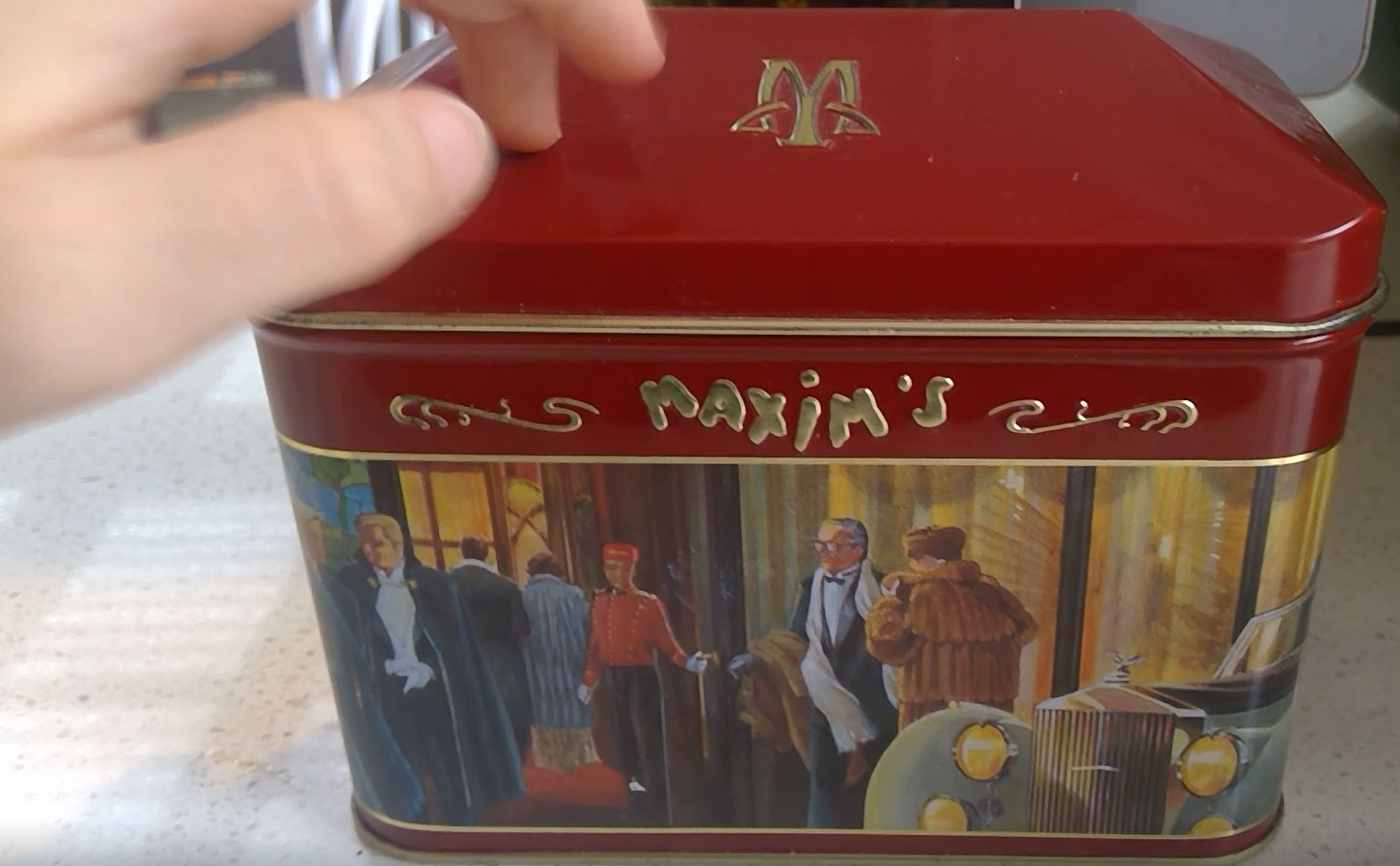 A vintage music tin with red lid