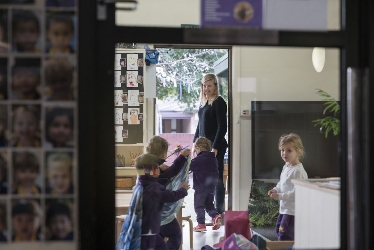 Teacher supervising children in a learning centre