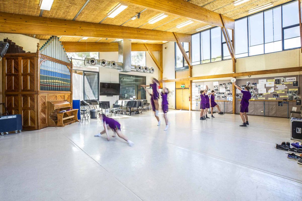 Children dancing on a large dance floor with a pipe organ in the background