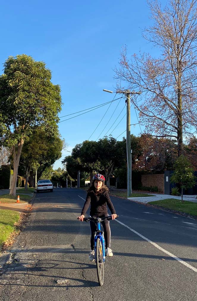 Year 9 student Laura Nayman rides her bike down the street