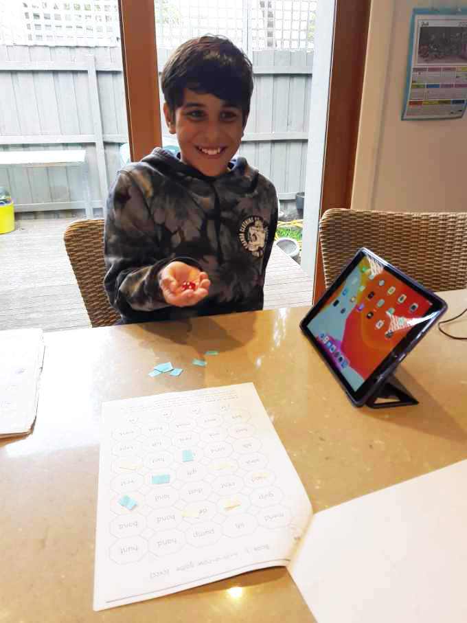 Student learning at home with Connect 4 game