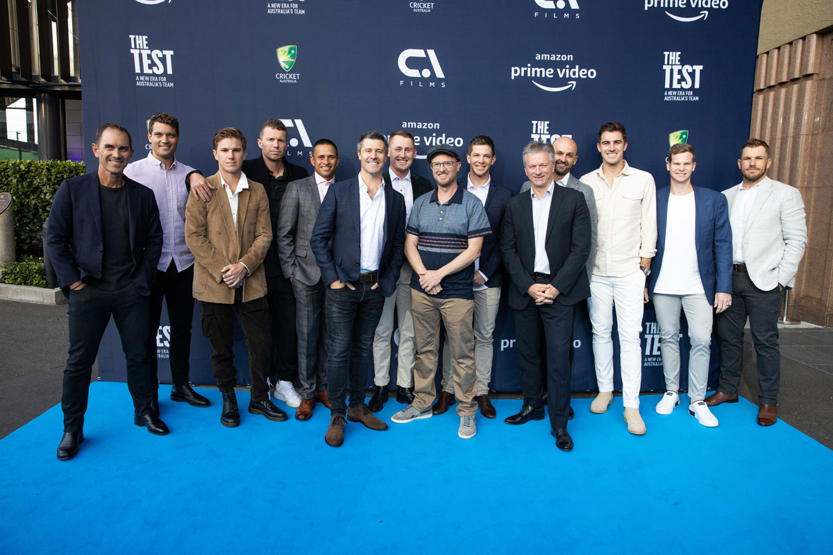 Andre Mauger stands with the Australian cricket team for a photoshoot