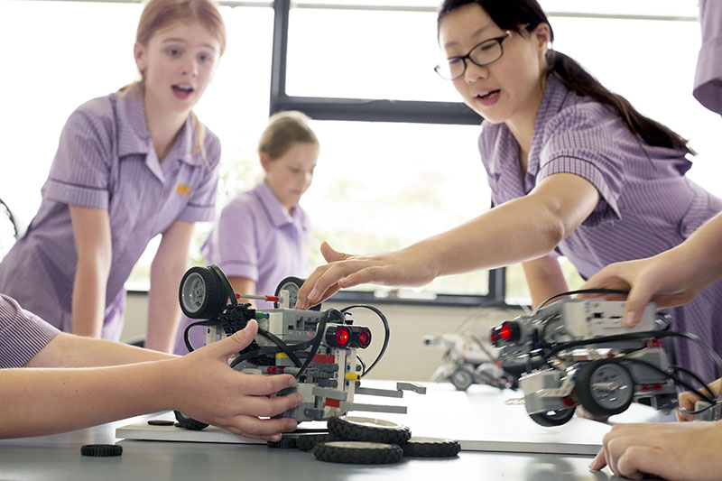 Wesley students building small device with wheels