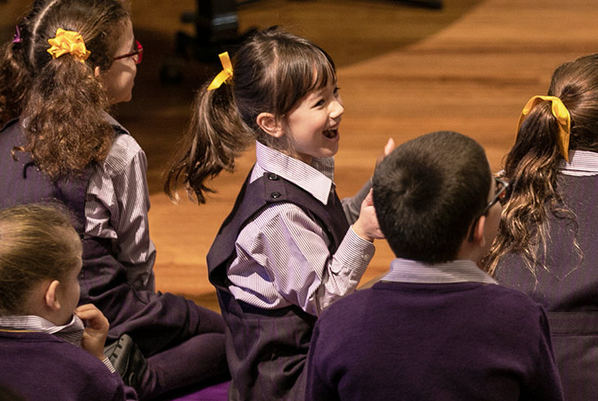 A young female child laughing and clapping