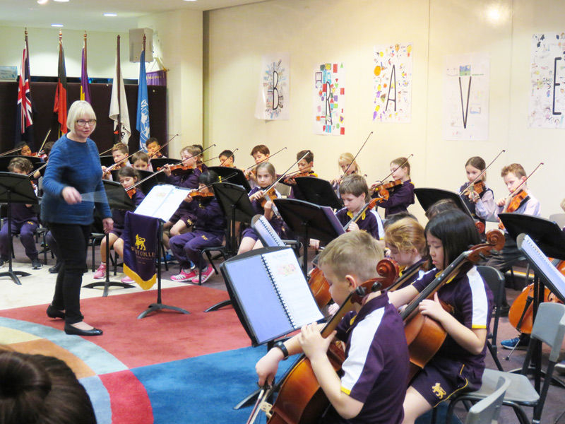 Year 2 students playing violins