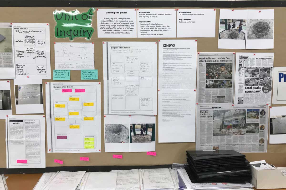 A display board showing examples of work including news articles