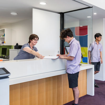 Student signing in at reception