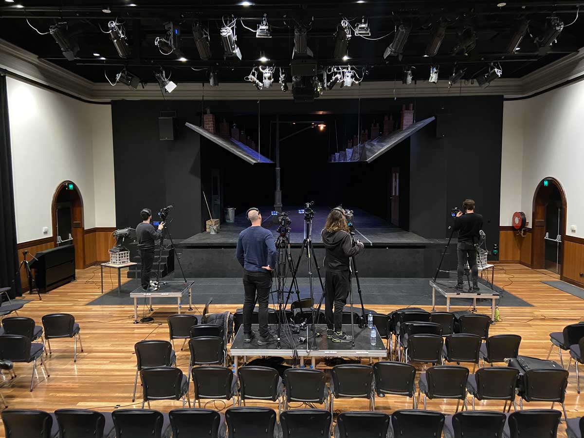 A film crew filming a stage without audience
