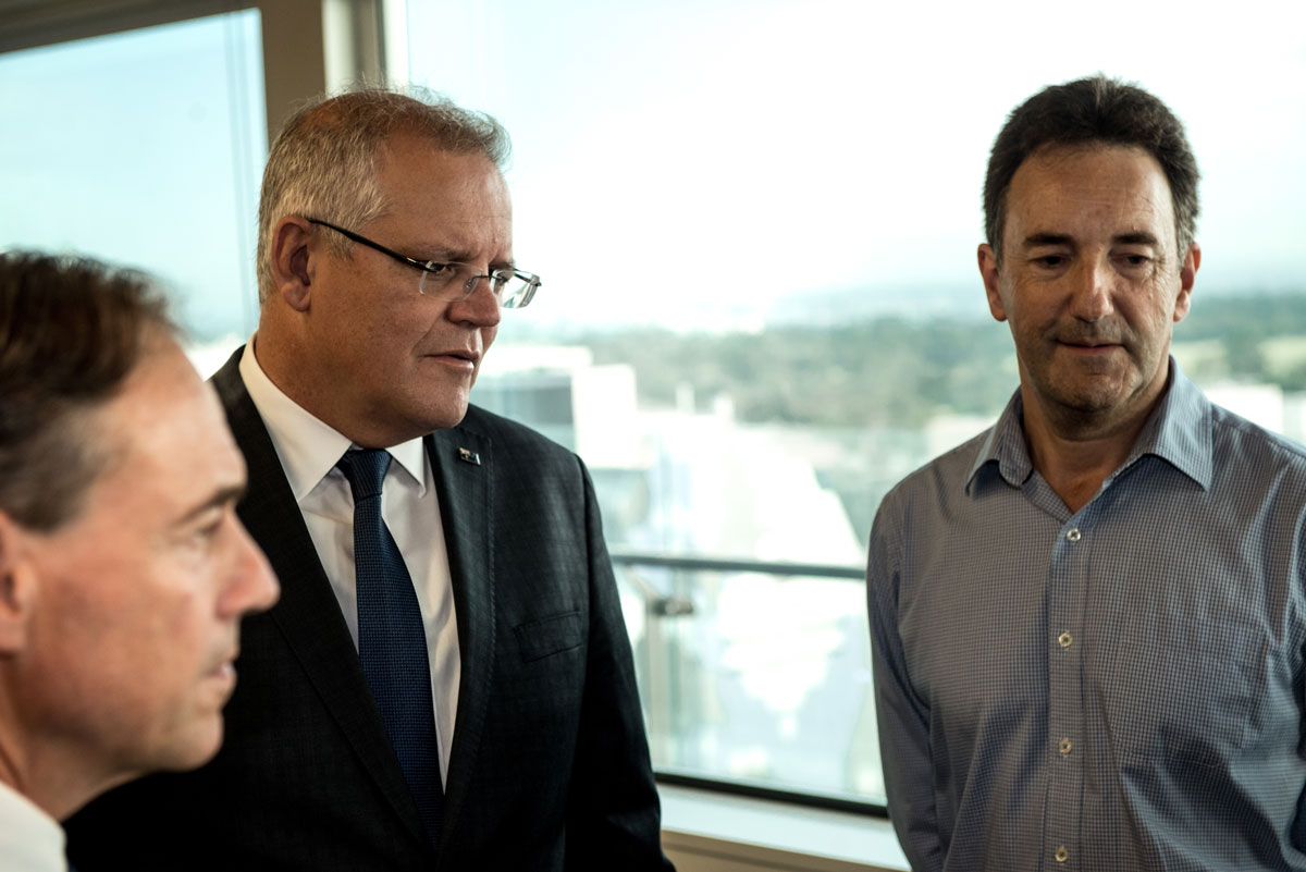 Prime Minister Scott Morrison stands beside Julian Druce