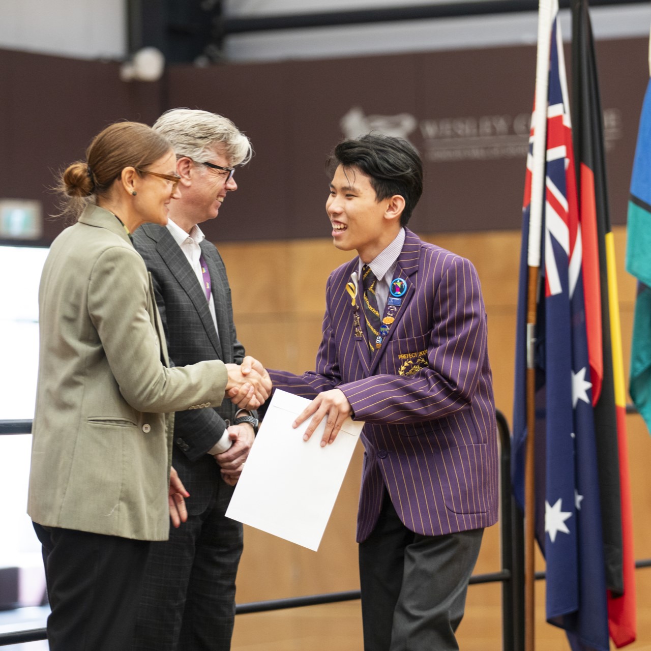  Forrest Lo receives an award from Head of Campus Sheriden Vella and Principal Nick Evans