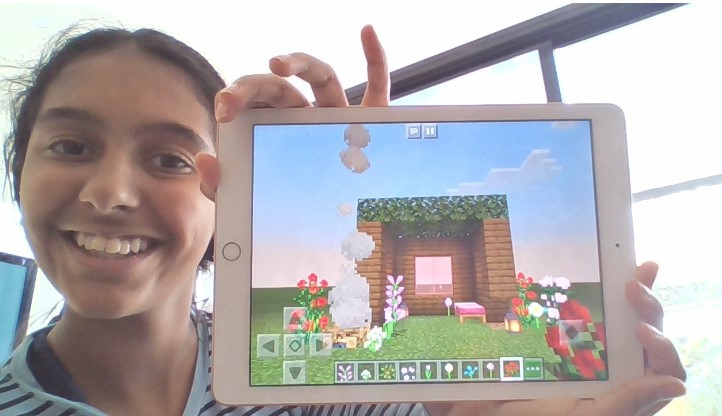Sierra shows her minecraft creation on her iPad
