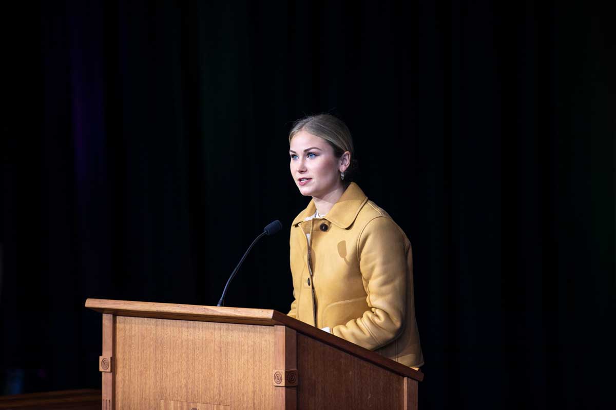 Grace Tame speaking at a lectern