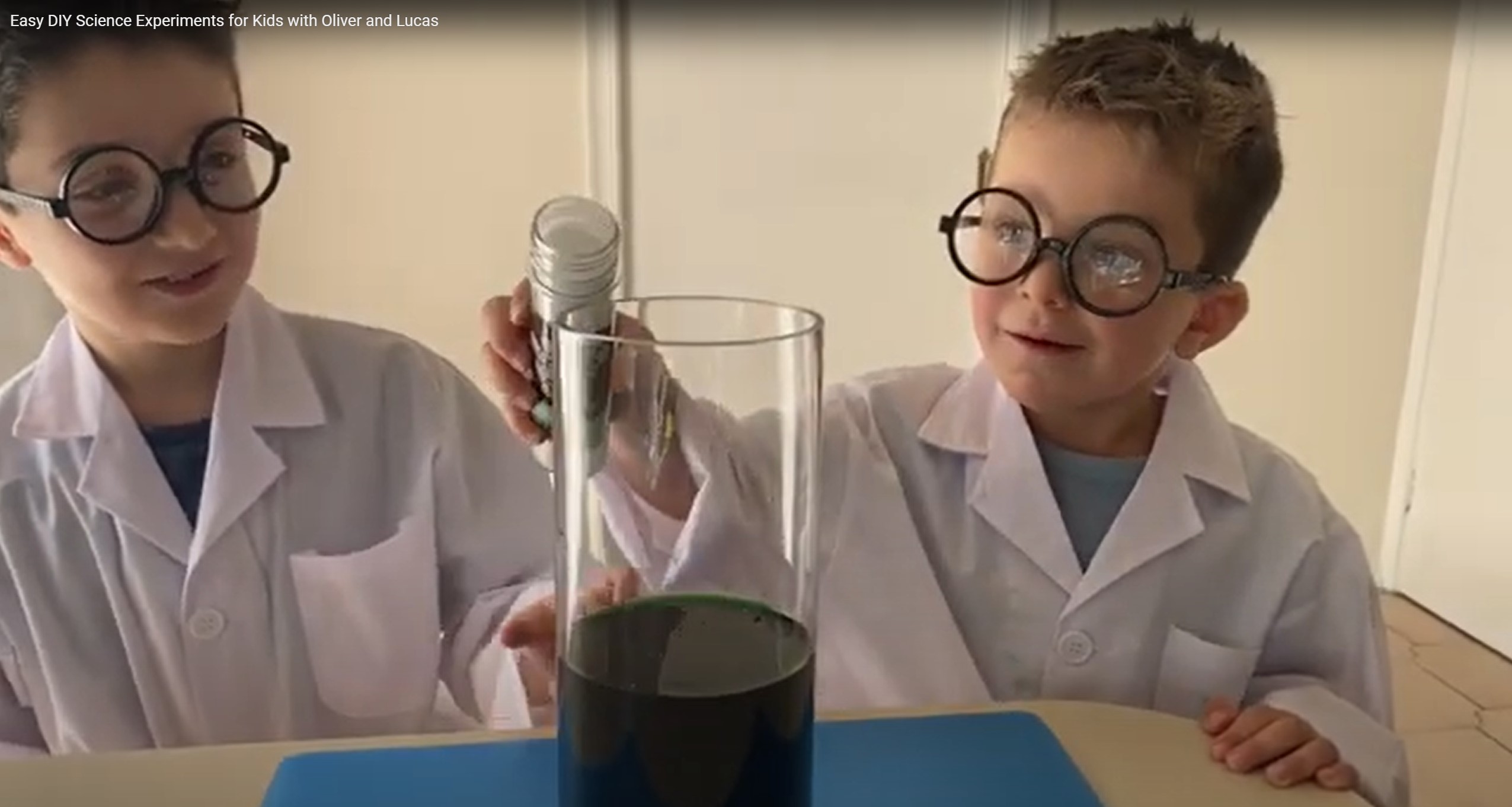Two brothers, Oliver and Lucas, in white lab coats pouring liquid into a beaker