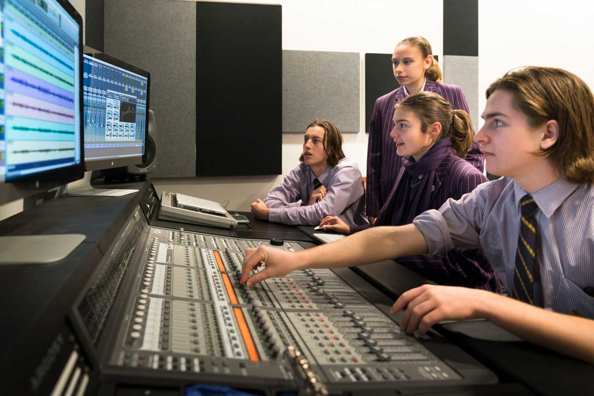 Girls and boys sound mixing in studio