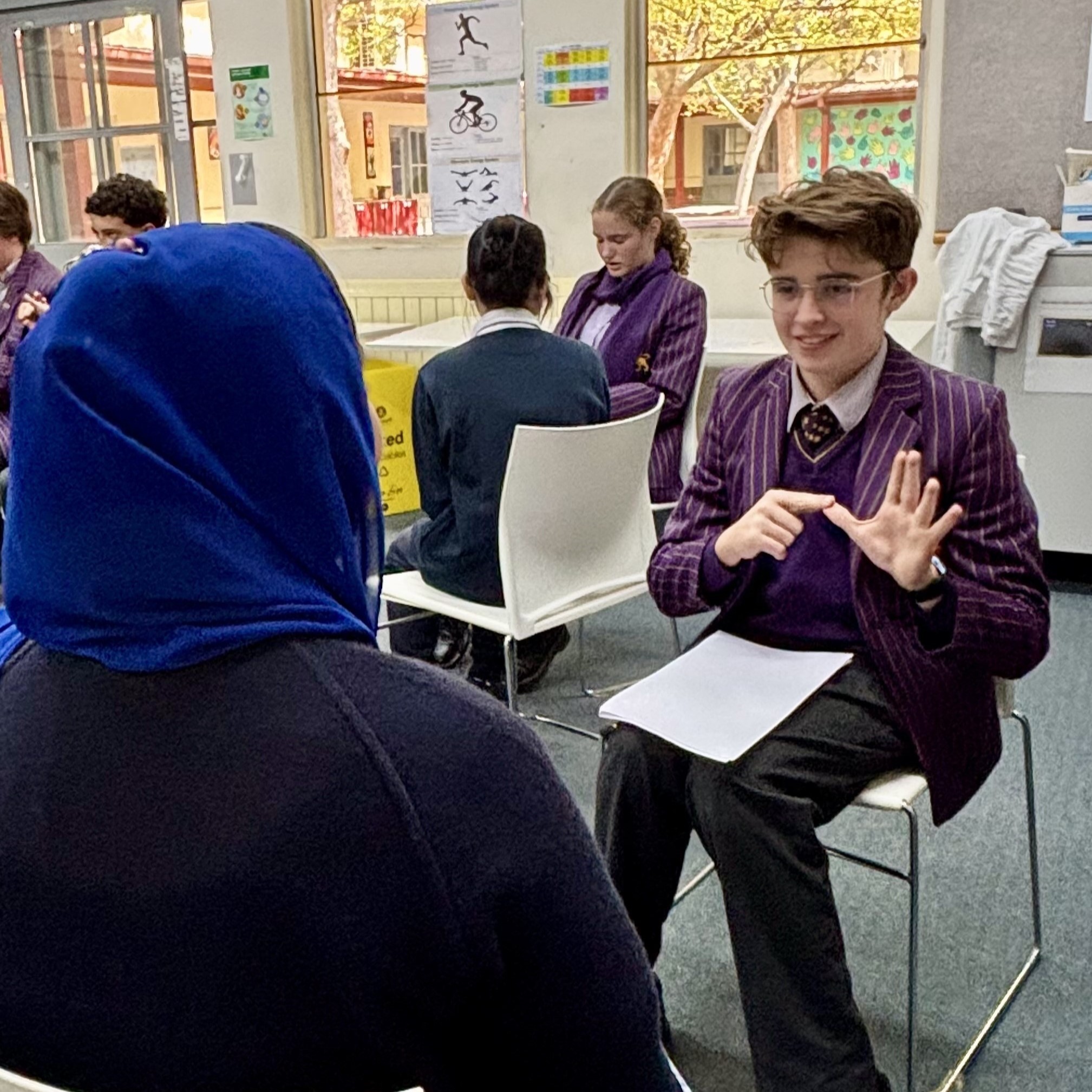 Wesley College student Harrison converses with Victorian College for the Deaf student in Auslan