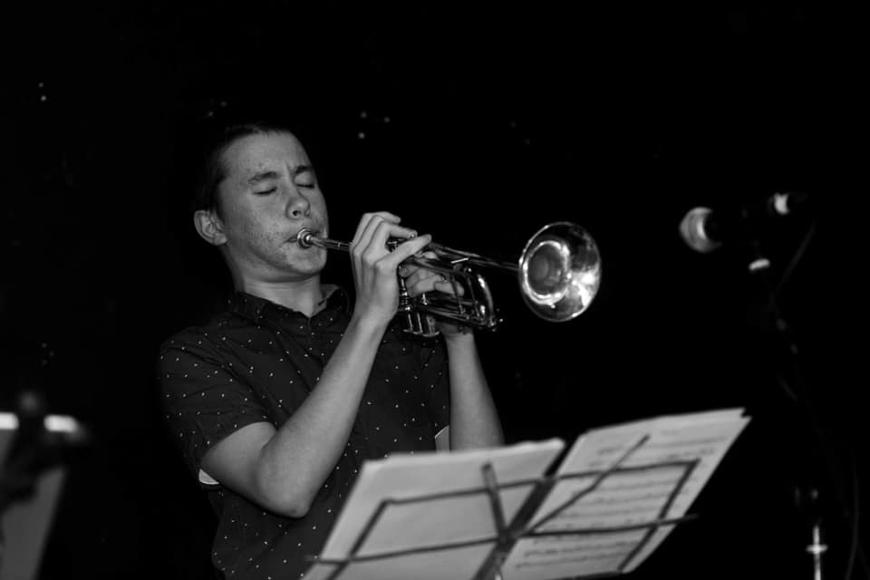 Thien plays the trumpet on stage