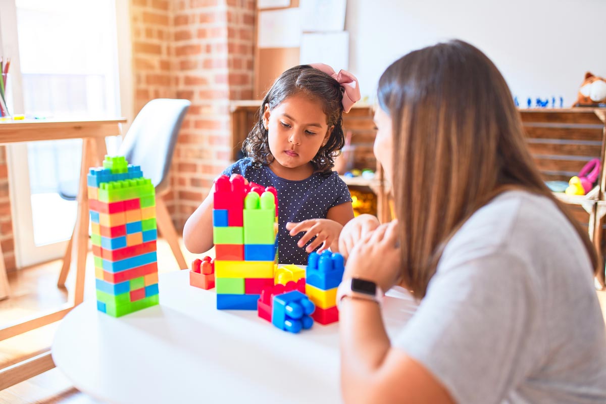 Mother and daughter playing with coloured blocks