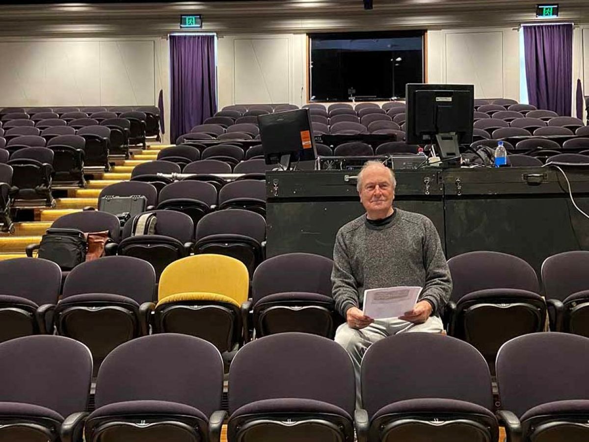 Dawson Hann sits alone in the audience seats at Adamson Theatre