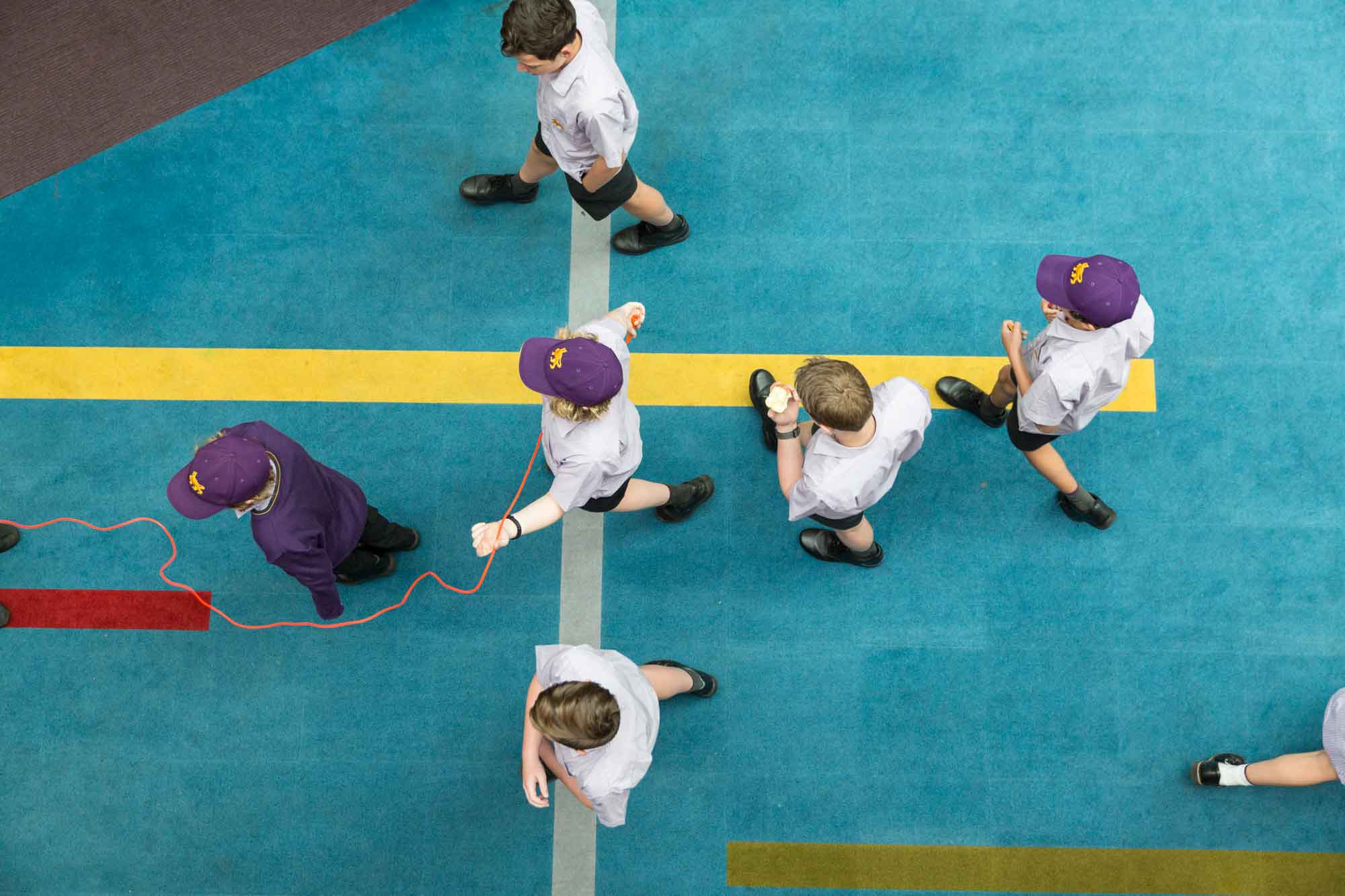 Top view of Wesley students walking in a cross shape